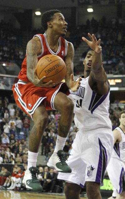 Brandon Jennings, left, scored 31 in the Bucks’ loss. (Associated Press)