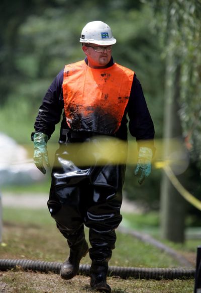 Eric Boyer, of Environmental Restoration, is covered in oil Saturday as cleanup from a ruptured pipeline continues in Marshall, Mich. Enbridge Energy Partners, which owns the pipeline, has received several safety warnings, the Transportation Department said.  (Andre J. Jackson)