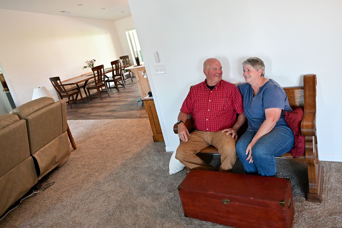 John and Cindy Altheide smile as they chat about rebuilding their home on Thursday after it was destroyed last year by the Gray fire in Medical Lake.  (Tyler Tjomsland/The Spokesman-Review)