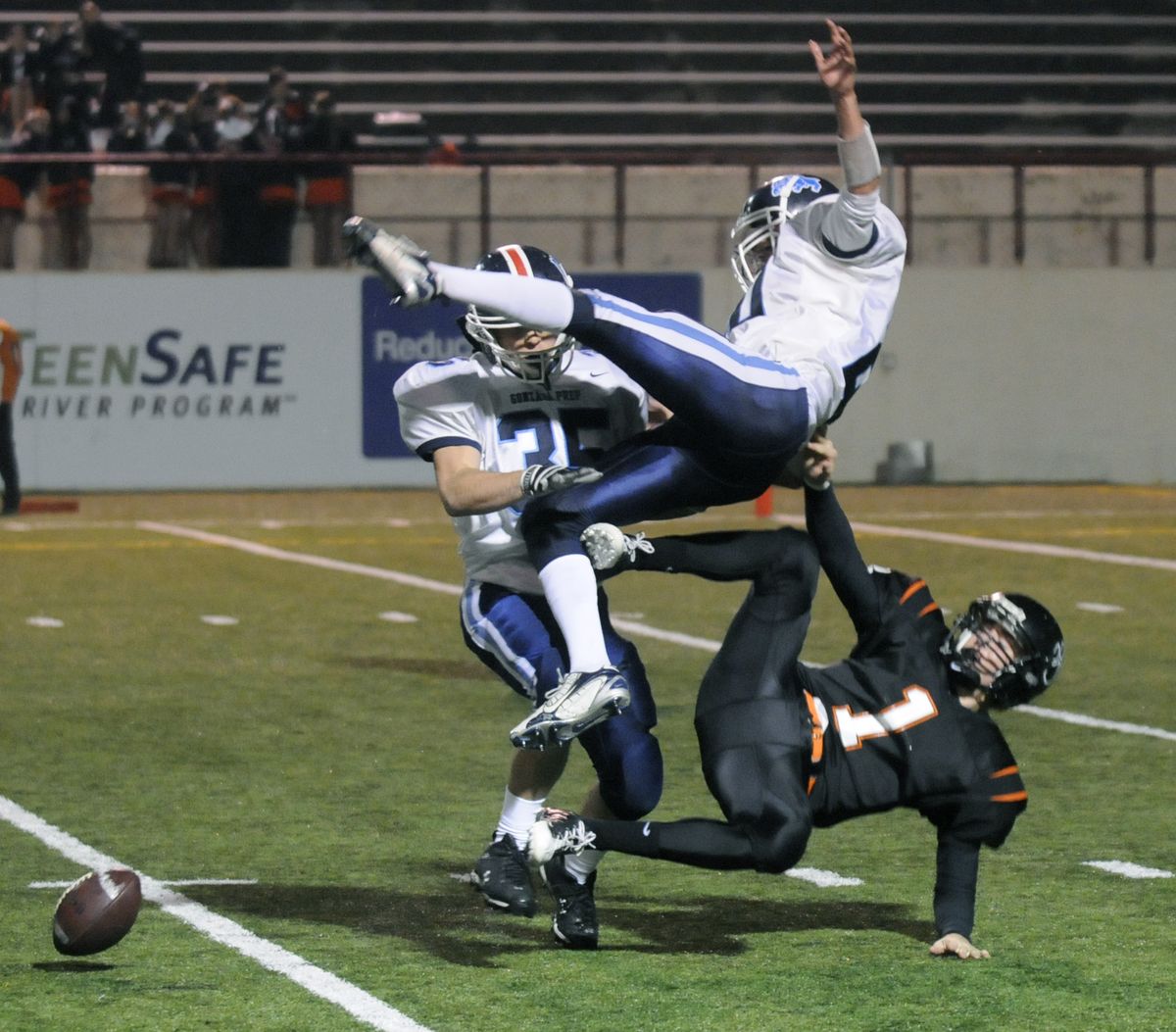 G-Prep’s Jack Wilson jumps over Lewis and Clark punter Austin Ehlo after blocking a kick. Prep’s Justin Roberts is also involved. (Dan Pelle / The Spokesman-Review)
