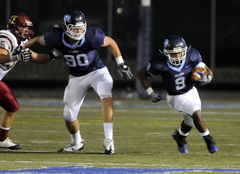 Six-foot-7 Charlie Hopkins runs interference for Gonzaga Prep running back Bishop Sankey in last Friday’s win over University.  (Jesse Tinsley)