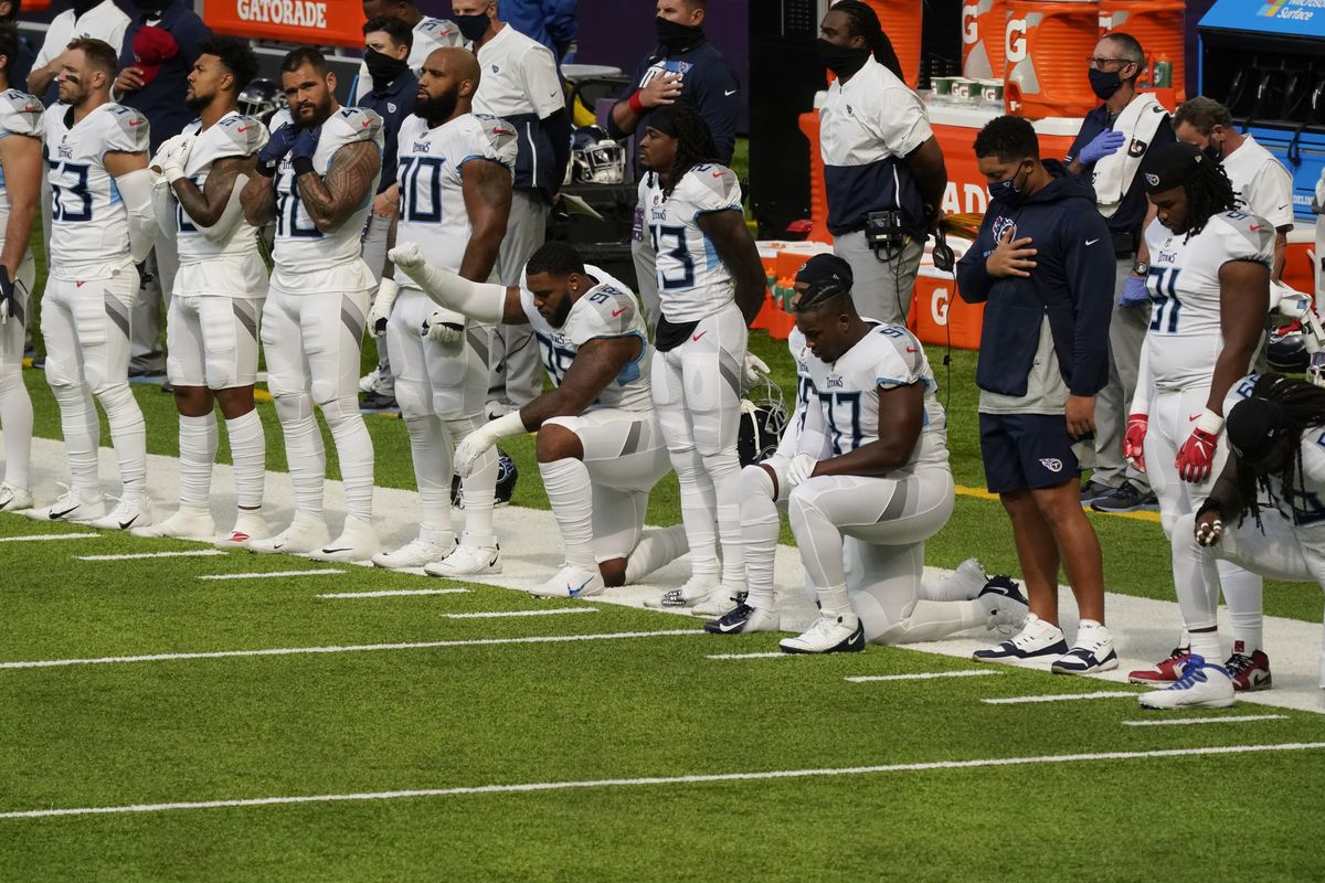 Members of the Tennessee Titans take part in the national anthem before an NFL football game against the Minnesota Vikings on Sept. 27, 2020 in Minneapolis. Tennessee will not be returning to the team's facility Wednesday, Oct. 7, 2020, after two more players tested positive in the NFL's first COVID-19 outbreak, a person familiar with the situation told The Associated Press.  (Jim Mone)