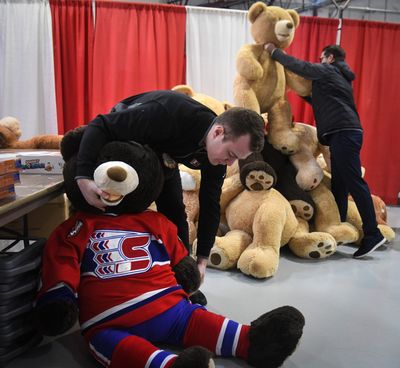 Brian Cobb, left, and Craig Maunder, of the Spokane Chiefs, deliver some of the 8600 teddy bears the team collected for the Spokesman-Review Christmas Bureau, Wednesday, Dec. 10, 2019, at the Spokane County Fair & Expo Center.  (Dan Pelle/The Spokesman-Review)