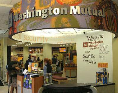 
The Washington Mutual Bank concierge desk is seen at the downtown Seattle branch. Washington Mutual earnings rose 9 percent in the first quarter.
 (Associated Press / The Spokesman-Review)