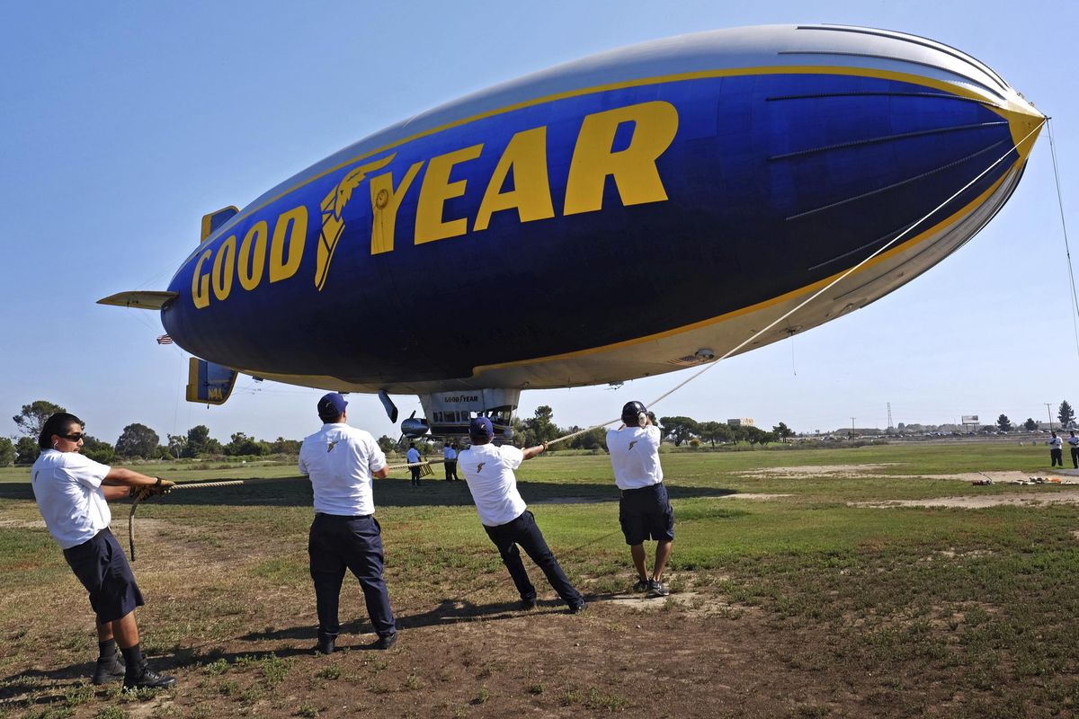 This Sept. 23, 2015, photo shows ground crew mooring the Goodyear Blimp “Spirit of Innovation” as it comes in for a landing at Goodyear Airship Base in Carson, Calif. Goodyear is letting the helium out of the last of its fabled fleet of blimps on Tuesday, March 14, 2017. Its replacement, “Wingfoot Two,” will look about the same when it arrives later this year, but it will be a semi-rigid dirigible. (Richard Vogel / Associated Press)