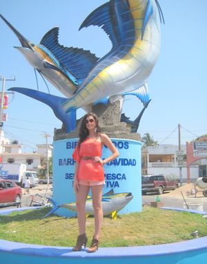 Miss Mexico, Karin Ontiveros, poses in front of a marlin and sailfish sculpture in Barra de Navidad.
 (John Jankovsky)