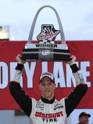 Brad Keselowski, driver of the #22 Discount Tire Dodge holds the trophy up after winning the NASCAR 5-hour Energy 250 at Gateway International Raceway. (Photo courtesy of John Sommers II/Getty Images for NASCAR) (John Ii / Getty Images North America)