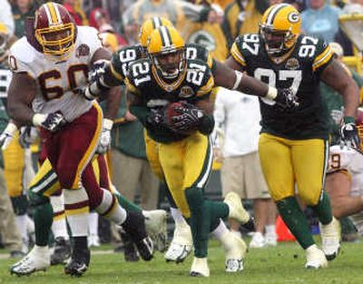 
Packers CB Charles Woodson (21) returns a fumble. Associated Press
 (Associated Press / The Spokesman-Review)