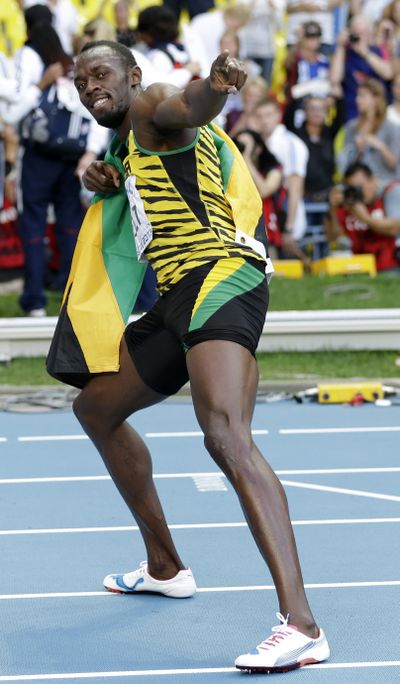 Jamaica’s Usain Bolt strikes a pose as he celebrates winning the men’s 200-meter final at the World Athletics Championships. (Associated Press)