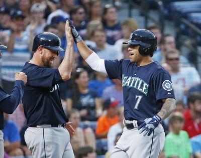 Former Seattle Mariners pinch-hitter Stefen Romero, right, celebrates his three-run homer with John Buck in the fourth inning of a baseball game against the Atlanta Braves on Tuesday, June 3, 2014 in Atlanta. Seattle won 7-5. (John Bazemore / Associated Press)