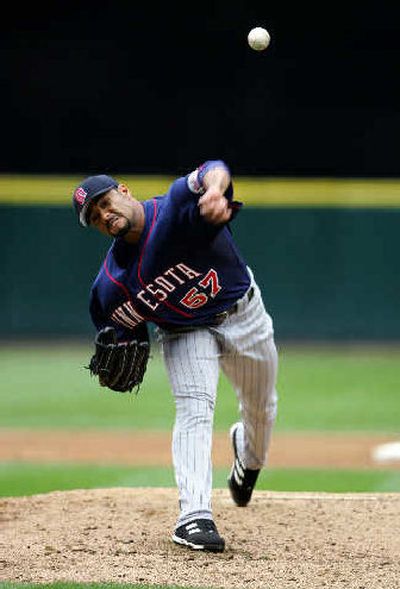 
Minnesota starter Johan Santana, who lasted five innings, works in the third. 
 (Associated Press / The Spokesman-Review)