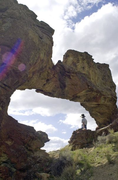 A person is framed by a beautiful rock formation at Leslie Gulch in Southeast Oregon. (Associated Press)