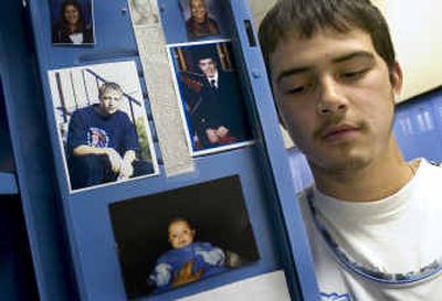 
Wellpinit High School's Jeryl Andrews,16, keeps photographs in his locker of his friends Robert McCoy, left, and Blu Madera who died within a week of each other. 
 (Colin Mulvany / The Spokesman-Review)