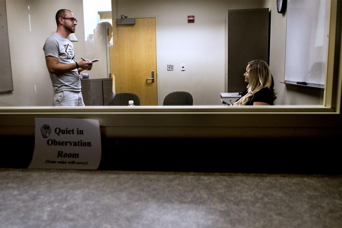 Tim Kinkaid reads a letter he wrote about the challenges of being a stutterer to clinician Bailey Bergdahl on Friday, July 14, 2017, at Eastern Washington University’s Health Science Building. (sr)