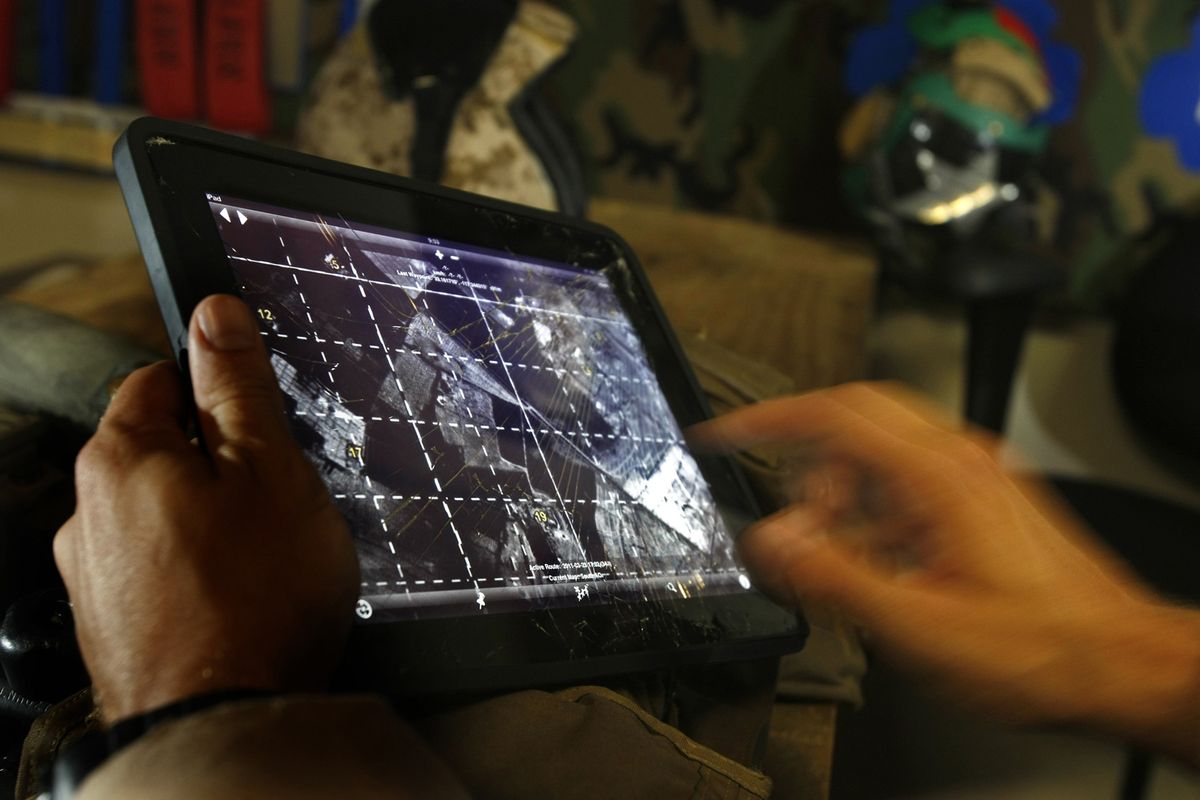 In a room at the Marine Corps Air Station Camp Pendleton, Capt. Jim Carlson reviews a satellite image on his iPad.