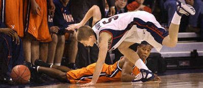 Gonzaga guard Derek Raivio lunges after a loose ball in front of Virginia's Sean Singletary.
(Brian Plonka / The Spokesman-Review)