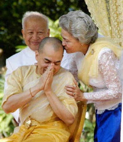 
Former King Norodom Sihanouk looks on as his wife Queen Monineath kisses his son and successor King Norodom Sihamoni at the bathing ceremony, one of the coronation ceremonies Friday at the Royal Palace in Phnom Penh.
 (Associated Press / The Spokesman-Review)