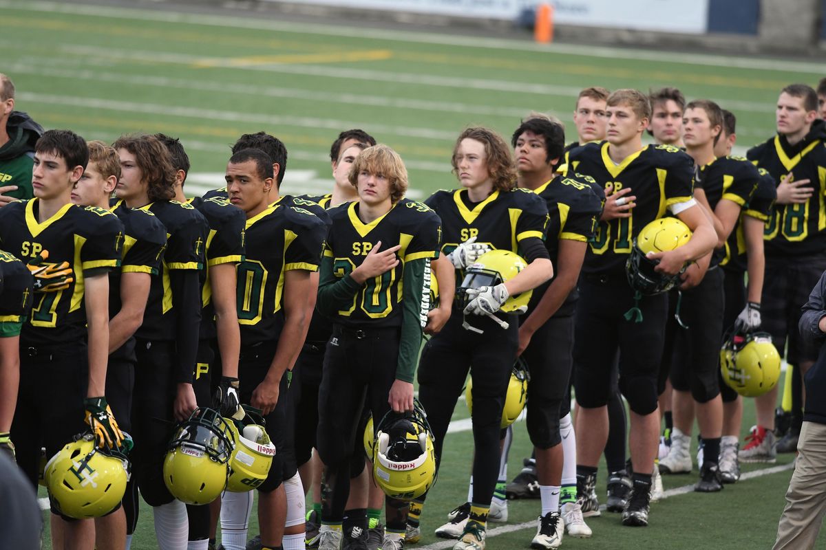 Shade Park football players listen to the Star-Spangled Banner before their game with U-Hi during at Joe Albi Stadium, Friday, Sept. 23, 2016, in Spokane, Wash. (Colin Mulvany / The Spokesman-Review)