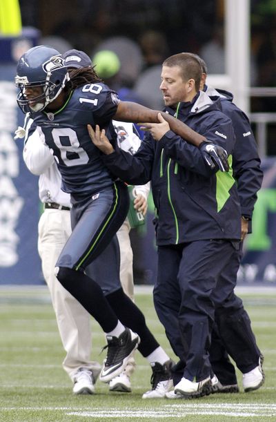Seahawks receiver Sidney Rice is aided after his injury against the Ravens. (Associated Press)