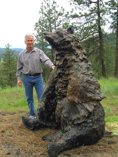 Artist Jerry McKellar stands next to Huckleberry Daze, a large bronze bear statue he sold at-cost to the Spokane Valley Arts Council.  (COURTESY OF GAYLE MCKELLAR)