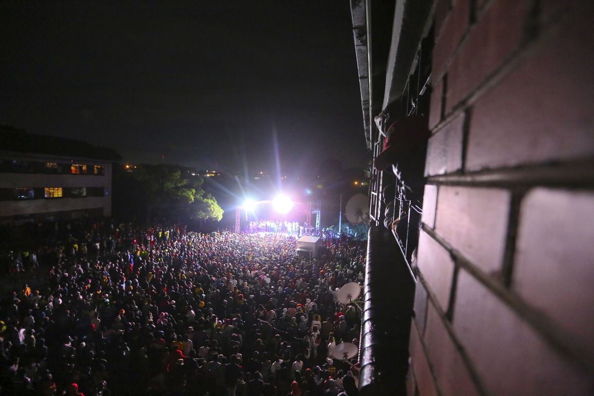 Thousands of people attend a music concert to celebrate the new year in Mbare, Harare, Friday, Jan 1, 2021. Despite a government ban on music concerts and public gatherings due to a surge in COVID-19 infections and the new and more contagious variants of the disease, thousands of people gathered in one of the country