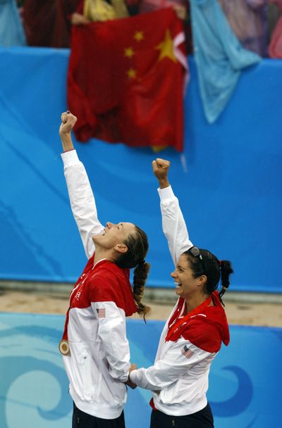 Kerri Walsh, left, and Misty May-Treanor celebrate their golden partnership during the  medal ceremony.  (Associated Press / The Spokesman-Review)