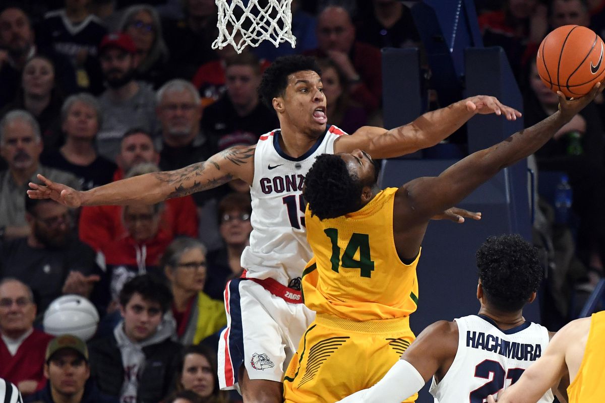 Gonzaga forward Brandon Clarke (15) tries to stop a shot by San Francisco guard Charles Minlend (14) during the second half of a college basketball game, Thurs., Feb. 7, 2019, at the McCarthey Athletic Center. (Colin Mulvany / The Spokesman-Review)