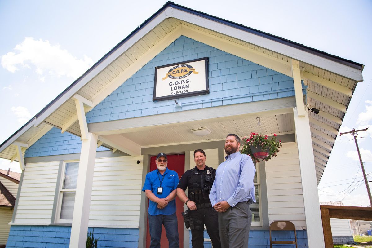 Community corrections officer Chris Schilling, neighborhood resource officer David Kaurin and Spokane C.O.P.S. executive director Patrick Striker pause for a photo Tuesday at the newly relocated Logan C.O.P.S. Shop at 2023 N. Perry St. (Libby Kamrowski / The Spokesman-Review)