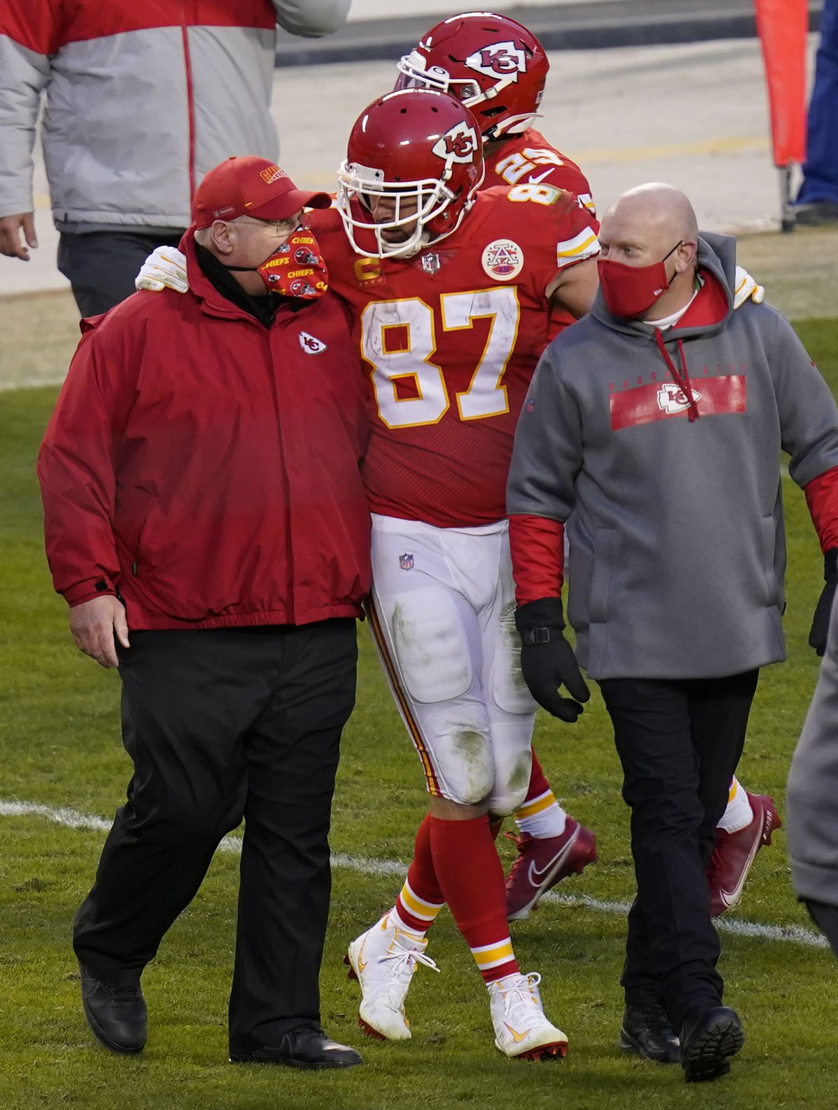 FILE - In this Jan. 17, 2021, file photo, Kansas City Chiefs tight end Travis Kelce (87) walks off the field with coach Andy Reid after an NFL divisional round football game against the Cleveland Browns in Kansas City, Mo. Both Reid and Bruce Arians are considered players’ coaches, though they do it in different ways. It