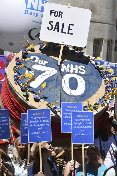 People march in central London to mark the 70th anniversary of the forming of the National Health Service (NHS), Saturday June 30, 2018. Various unions and interested groups gathered Saturday to celebrate the forming of the NHS and call for better funding for the British health service. (John Stillwell / PA)