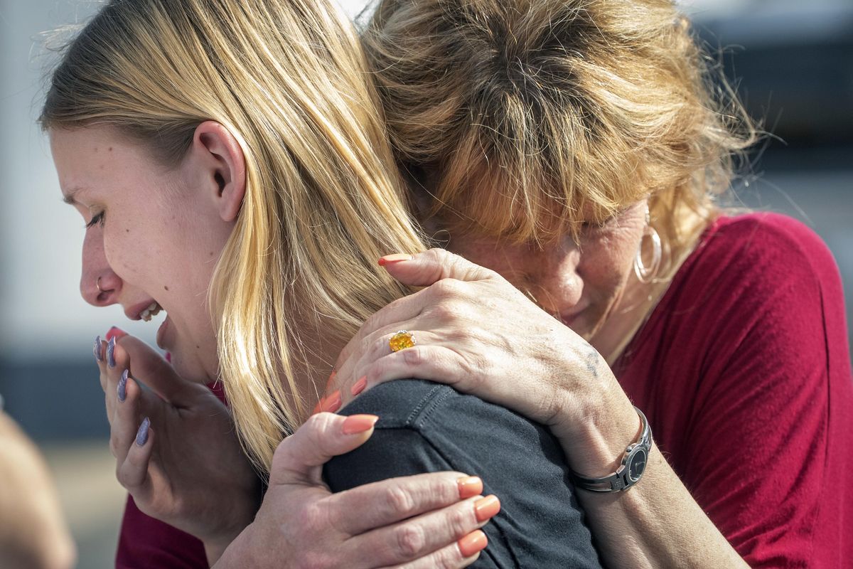 Santa Fe High School student Dakota Shrader is comforted by her mother Susan Davidson following a shooting at the school on Friday, May 18, 2018, in Santa Fe, Texas. Shrader said her friend was shot in the incident. (Stuart Villanueva/The Galveston County Daily News / Associated Press)