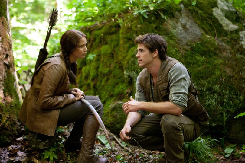 Jennifer Lawrence as Katniss Everdeen, left, and Liam Hemsworth as Gale Hawthorne in a scene from “The Hunger Games.”