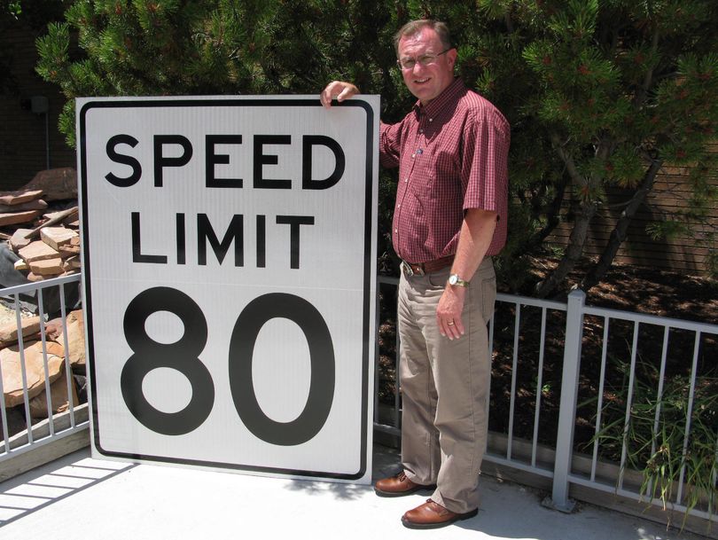 Blake Rindlisbacher, head of engineering services for the Idaho Transportation Department, shows one of the new 80 mph signs. “The faster you go, the bigger the signs are, so you can see them as you go by,” he said. (Betsy Z. Russell)