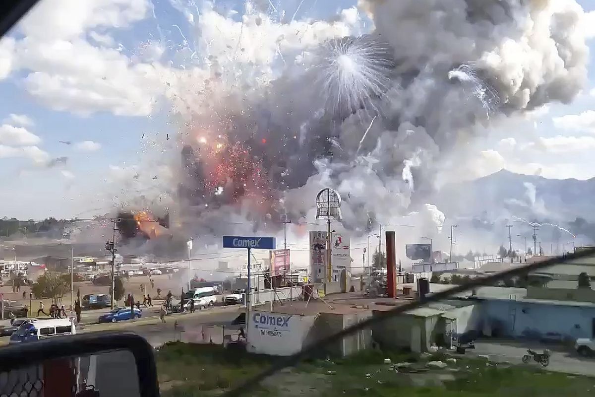 This image made from video recorded from a passing car shows an explosion ripping through the San Pablito fireworks’ market in Tultepec, Mexico, Tuesday. (Jose Luis Tolentino / Associated Press)