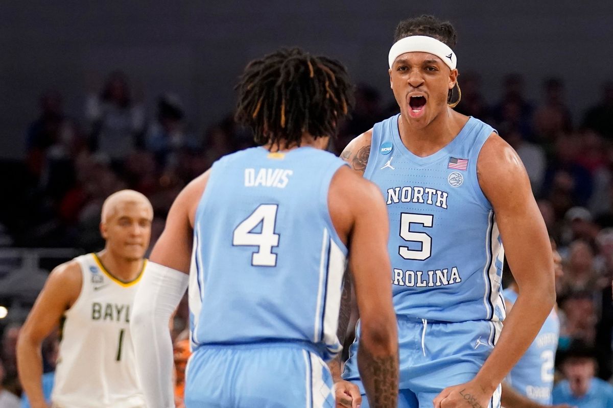 North Carolina guard RJ Davis (4) and forward Armando Bacot (5) celebrate in the second half of a second-round game against Baylor in the NCAA college basketball tournament in Fort Worth, Texas, Saturday, March, 19, 2022.  (Tony Gutierrez)