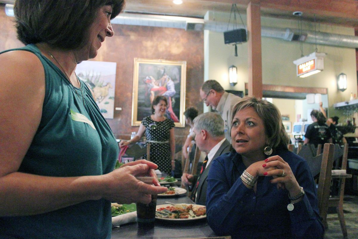 New Mexico Gov. Susana Martinez, right, takes a break from lunch to talk about green chiles during a visit to the Range Cafe in Bernalillo, N.M., on Tuesday. (Associated Press)