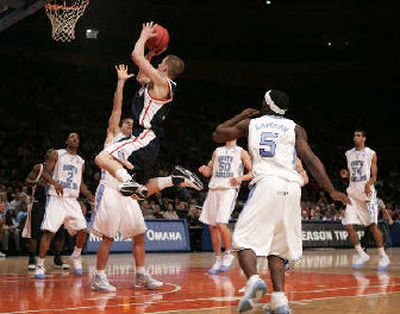 
Gonzaga's Derek Raivio, center, drives the lane for a shot against North Carolina's Wes Miller in the first half on Wednesday. 
 (Associated Press / The Spokesman-Review)