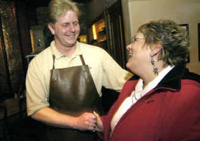 
Joe Mangum comes out of the kitchen at Catacombs Pub to reunite with Linda Krakora Friday night. Mangum used the Heimlich maneuver to save her from choking Thursday night while she ate at the restaurant. Mangum works in the kitchen. 
 (Christopher Anderson/ / The Spokesman-Review)