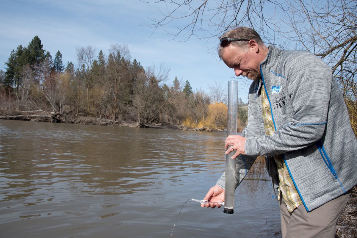 Jerry White, the Spokane Riverkeeper, checks the turbidity of Hangman Creek in this April 2019 photo. The Ecology Department announced last month $1.75 million in grants and loans  (Eli Francovich)
