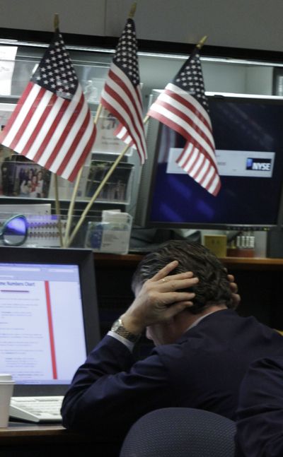 A trader works in a booth on the floor of the New York Stock Exchange on Wednesday. (Associated Press)