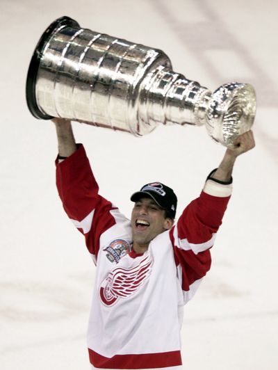 Defenseman Chris Chelios skates with the Stanley Cup in Detroit in 2002. He won three Cups during his 26-year NHL career. (Associated Press)