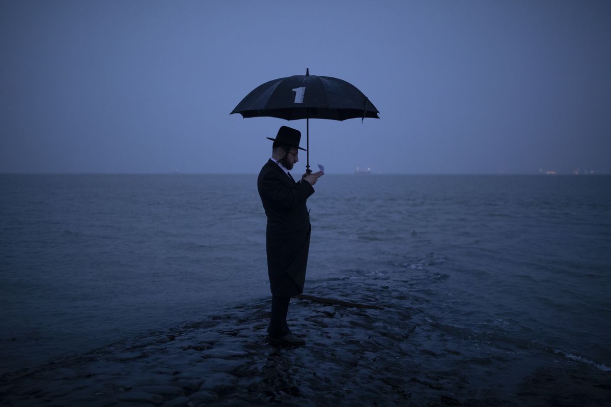 Joel Friedman observes Tashlich beside the seafront at dusk on Sept. 24, 2020, in Canvey Island, England. The atonement ritual of Tashlich is performed between the holy days of Rosh Hashanah and Yom Kippur. Getty Images  (Dan Kitwood)
