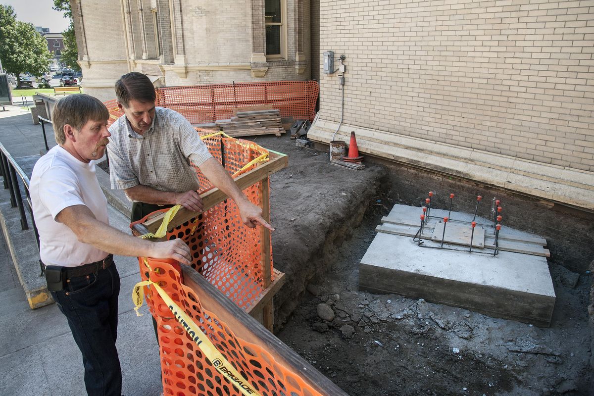 Ron Oscarson, Spokane County facilities director, right, shows Chuck King the location for courthouse iron gates restoration project on Tuesday. (Dan Pelle / The Spokesman-Review)