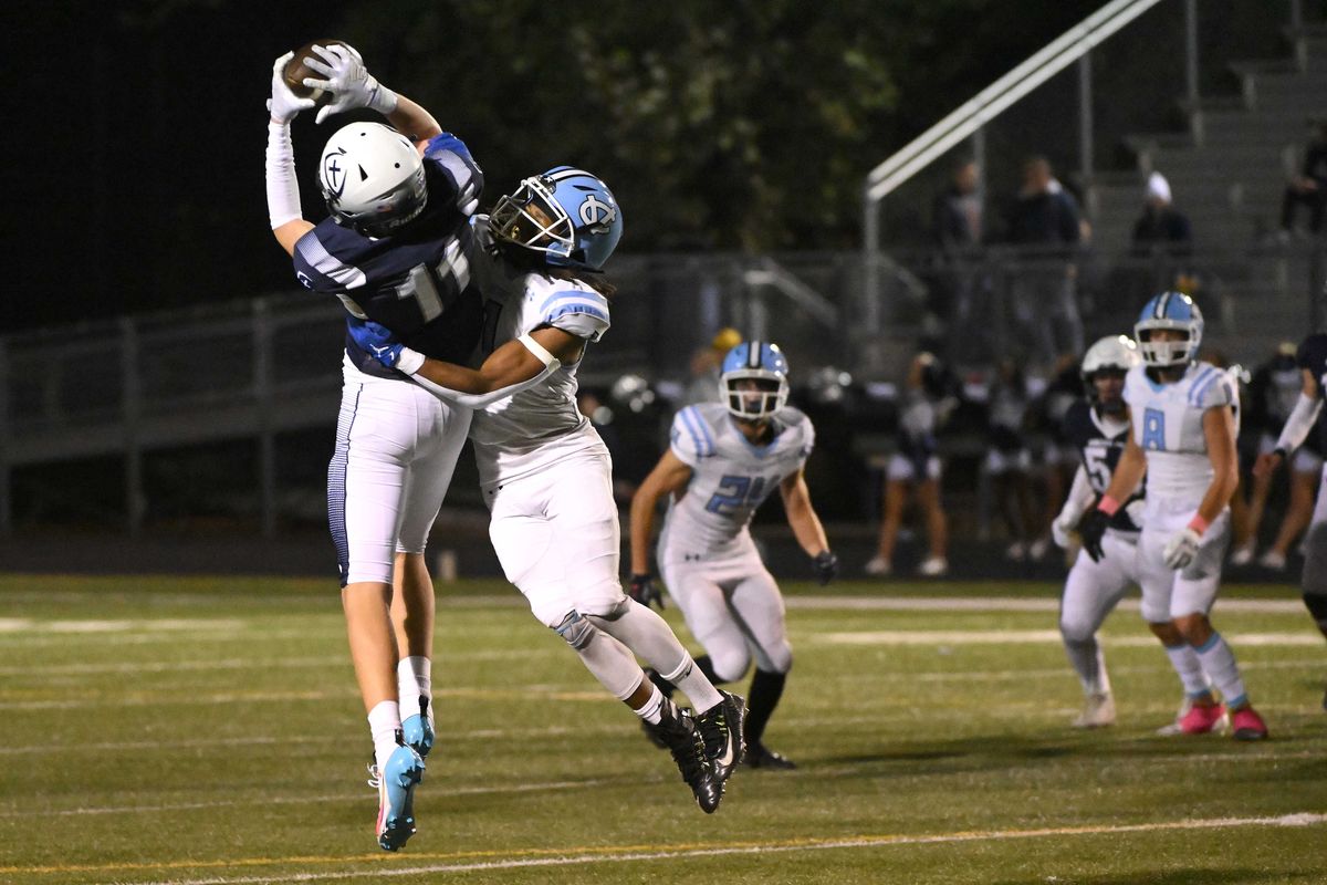 Gonzaga Prep’s Isaiah Docken makes a reception against Central Valley’s Kimoni Davis during the first half Friday at Gonzaga Prep.  (James Snook)