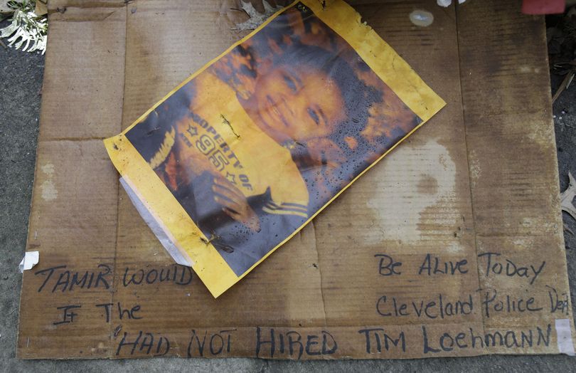 A photo of Tamir Rice rests on the ground near a memorial outside the Cudell Recreation Center, Tuesday, Dec. 29, 2015, in Cleveland. A grand jury on Monday declined to criminally indict the two officers in Tamir's killing in November 2014 at the recreation center.
