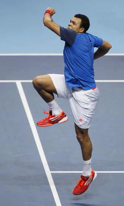 Jo-Wilfried Tsonga of France celebrates after beating Rafael Nadal of Spain to reach the semifinals in the ATP World Tour Finals. (Associated Press)