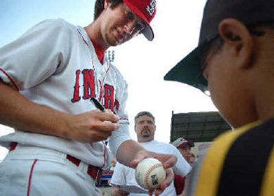 
Spokane Indians pitcher Patrick Donovan, who pitched for Gonzaga University, is a hometown favorite as he autographs baseballs before a game. 
 (Holly Pickett / The Spokesman-Review)