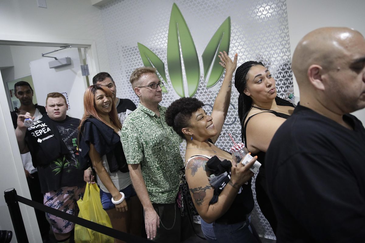People wait in line at the Essence cannabis dispensary, Saturday, July 1, 2017, in Las Vegas. Nevada dispensaries were legally allowed to sell recreational marijuana starting at 12:01 a.m. Saturday. (John Locher / Associated Press)