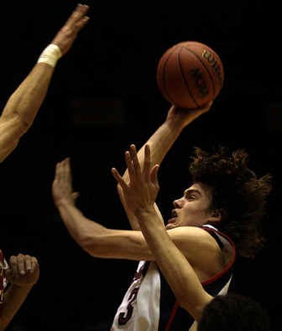 Gonzaga forward Adam Morrison knifes through the Winthrop defense en route to a game-high 27 points in the first round of the NCAA Tournament. 
 (Brian Plonka / The Spokesman-Review)