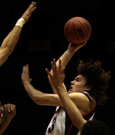 Gonzaga forward Adam Morrison knifes through the Winthrop defense en route to a game-high 27 points in the first round of the NCAA Tournament. 
 (Brian Plonka / The Spokesman-Review)